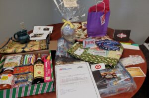 A table holding different prizes available in the 2021 RSVP Sweepstakes, including food and wine giftboxes and gift cards